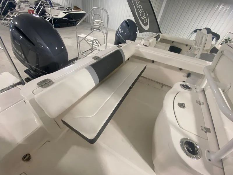 Slide: The Image of 2024 Robalo R222 boat interior with seating and dual outboard motors. - 3