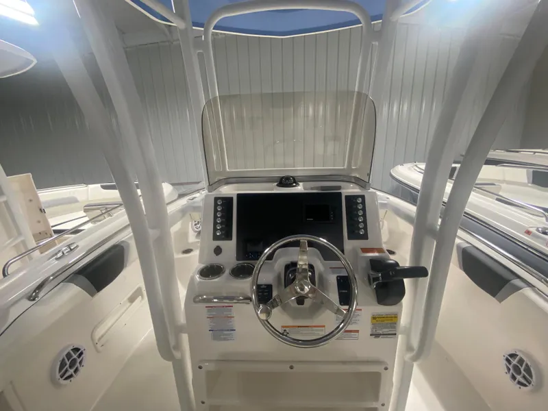 Slide: The Image of 2024 Robalo R222 boat dashboard with steering wheel and control panel. - 7