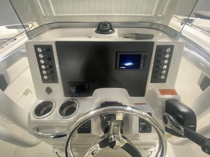 Slide: The Image of 2024 Robalo R222 boat dashboard with steering wheel and control panel. - 8