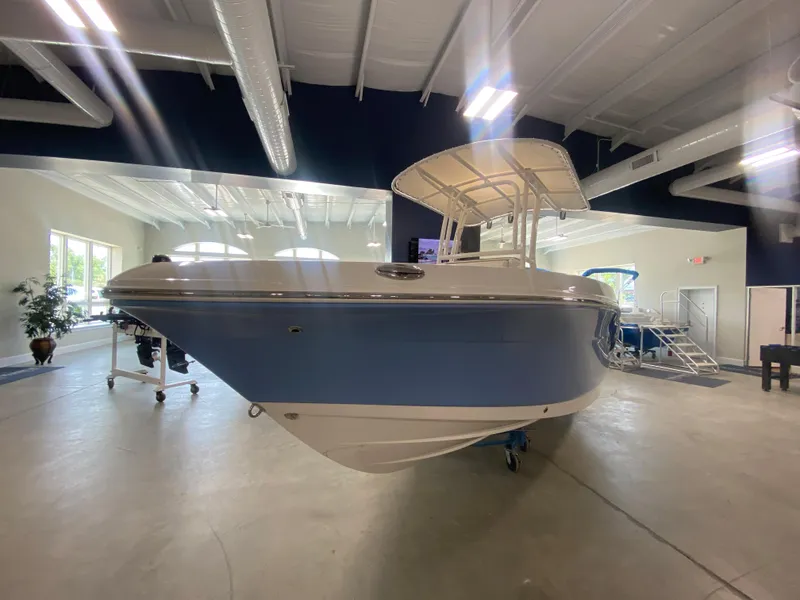 Slide: The Image of 2024 Robalo 202 EXPLORER boat displayed in a showroom. - 2