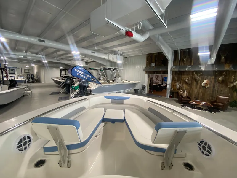 Slide: The Image of 2024 Robalo 202 EXPLORER boat interior in showroom with seating and modern design. - 7
