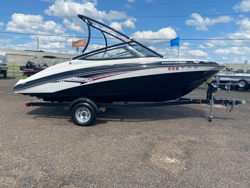 Slide: The Image of 2014 Yamaha Boats AR192 on trailer, side view, black and white, sunny day. - 12