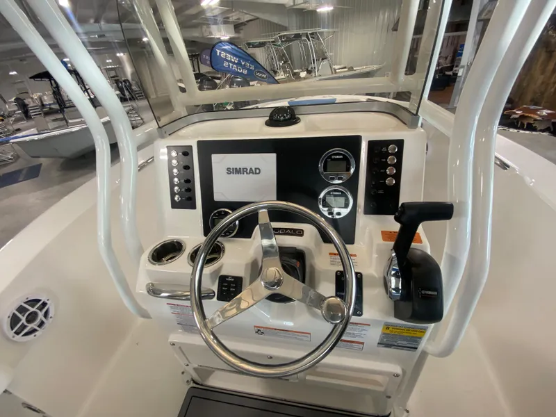Slide: The Image of 2024 Robalo 202 EXPLORER boat dashboard with steering wheel and controls. - 13