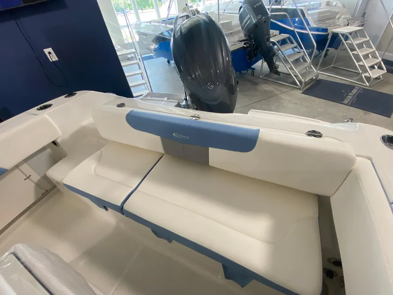 Slide: The Image of 2024 Robalo 202 EXPLORER boat interior with cushioned seating and outboard motor. - 18