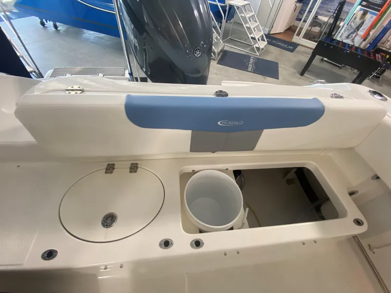 Slide: The Image of 2024 Robalo 202 EXPLORER boat interior with storage compartments and bucket. - 19