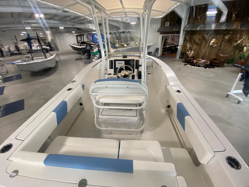 Slide: The Image of 2024 Robalo 202 EXPLORER boat interior with seating and console in showroom. - 6