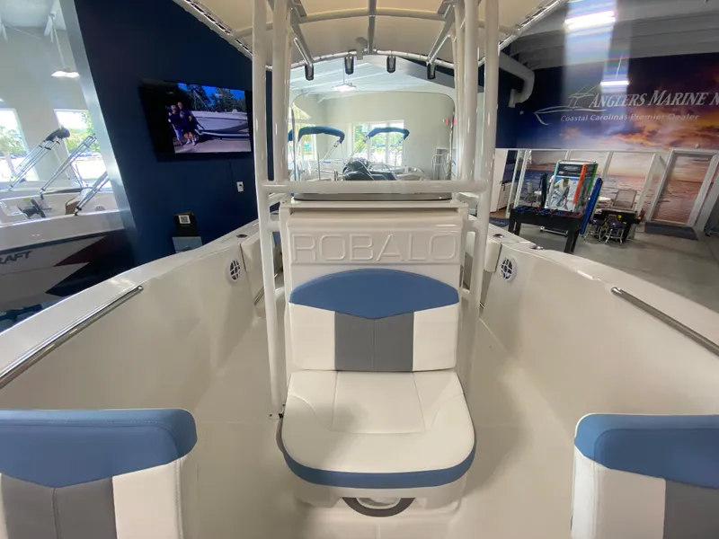 Slide: The Image of 2024 Robalo 202 EXPLORER boat interior with white and blue seating. - 11