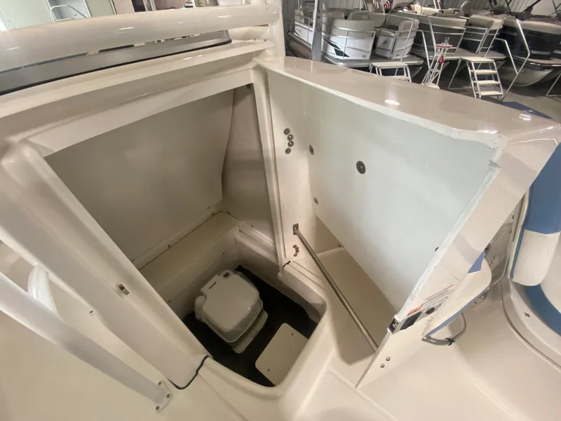 Slide: The Image of 2024 Robalo 202 EXPLORER boat interior with open storage compartment. - 12