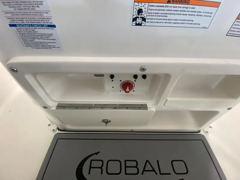 Slide: The Image of 2024 Robalo 202 EXPLORER boat control panel and storage compartments. - 14