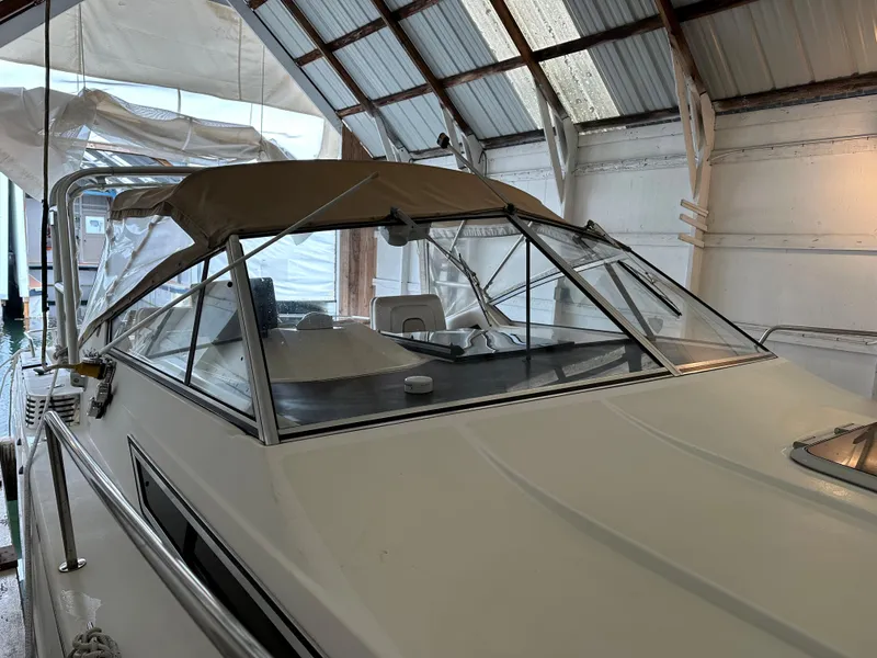 The Image of 1993 Wellcraft St Tropez 3200 boat in covered storage. - 0