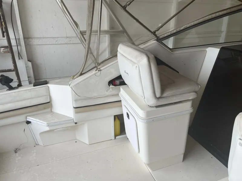 Slide: The Image of 1993 Wellcraft St Tropez 3200 boat interior with white seating and helm station. - 10