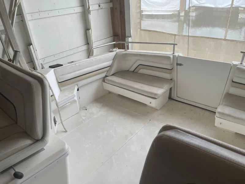 Slide: The Image of 1993 Wellcraft St Tropez 3200 boat interior with white seating and spacious layout. - 13