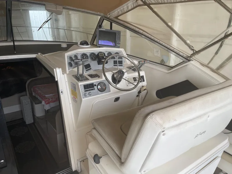 Slide: The Image of 1993 Wellcraft St Tropez 3200 boat cockpit with steering wheel and control panel. - 17