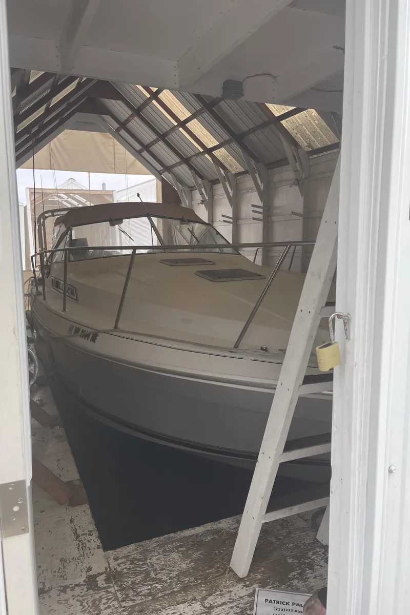 Slide: The Image of 1993 Wellcraft St Tropez 3200 boat stored in a covered shed. - 2