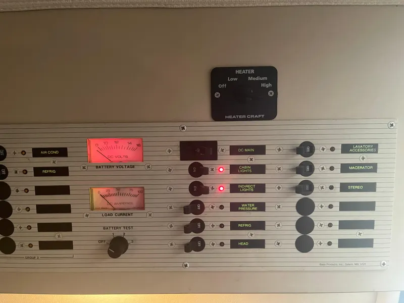 Slide: The Image of Control panel of a 1993 Wellcraft St Tropez 3200 boat with various switches and gauges. - 26