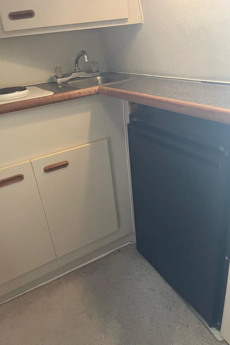 Slide: The Image of 1993 Wellcraft St Tropez 3200 kitchen area with sink and cabinets - 31