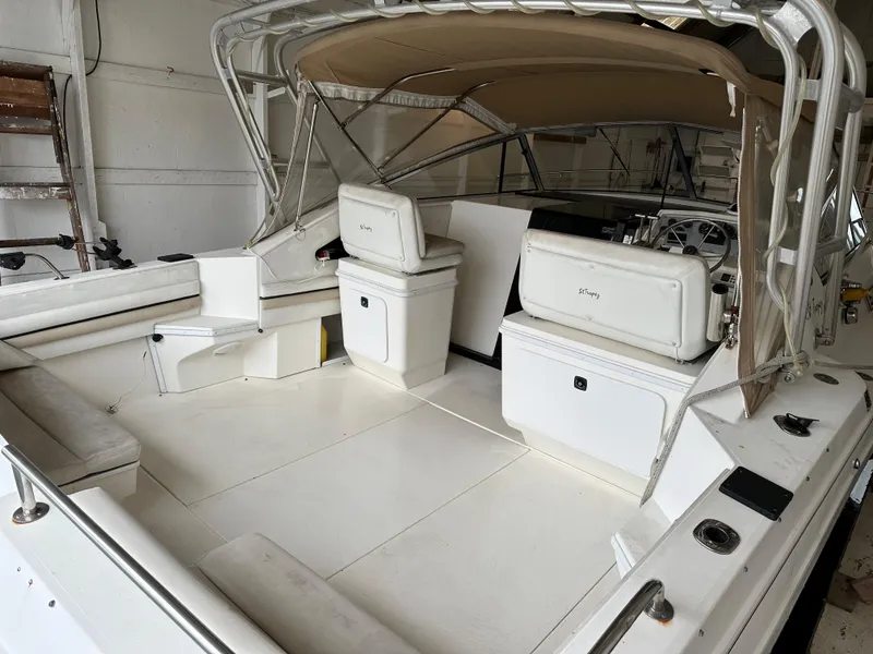Slide: The Image of 1993 Wellcraft St Tropez 3200 boat interior with beige canopy and white seating. - 34