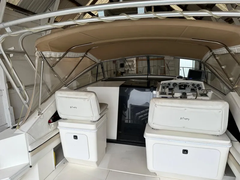 Slide: The Image of 1993 Wellcraft St Tropez 3200 boat interior with beige canopy and white seating. - 35