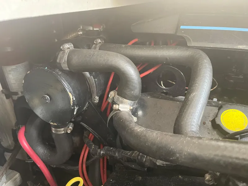 Slide: The Image of Engine compartment of a 1993 Wellcraft St Tropez 3200 boat with visible hoses and components. - 7