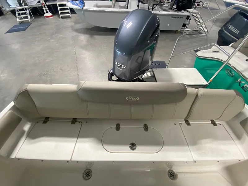 Slide: The Image of 2024 Key West 219 FS boat with Yamaha 175 engine, rear seating and storage compartments. - 11