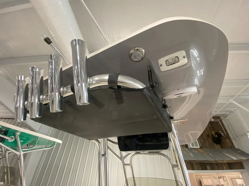 Slide: The Image of 2024 Key West 219 FS boat with rod holders and T-top in a showroom. - 13