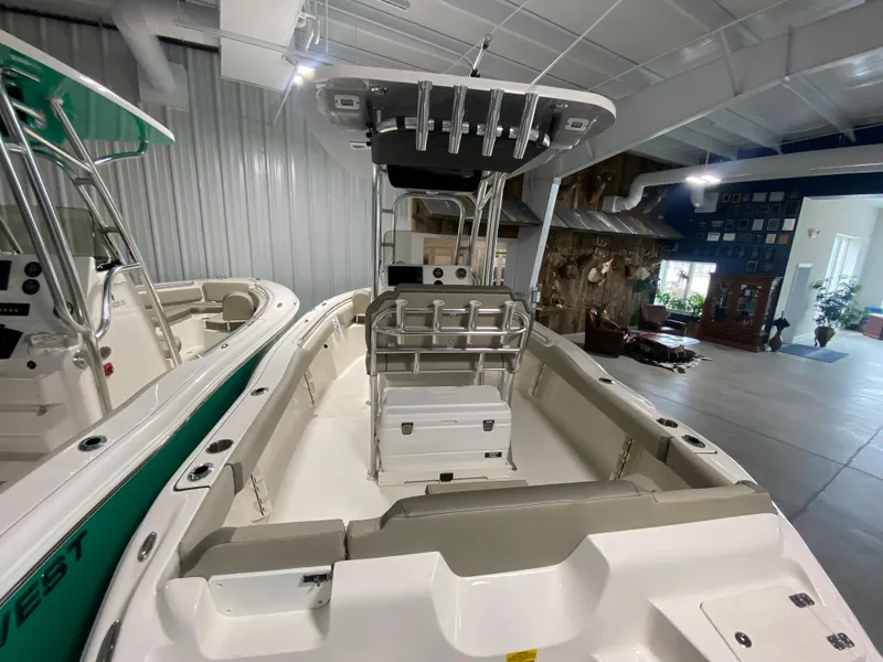 Slide: The Image of 2024 Key West 219 FS boat interior in showroom, featuring center console and seating. - 3