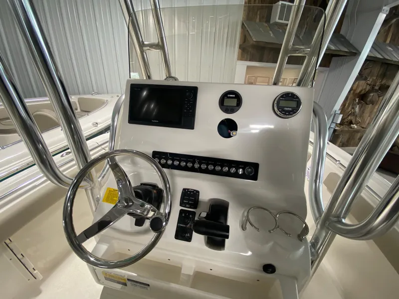 Slide: The Image of 2024 Key West 219 FS boat console with steering wheel and electronic controls. - 7