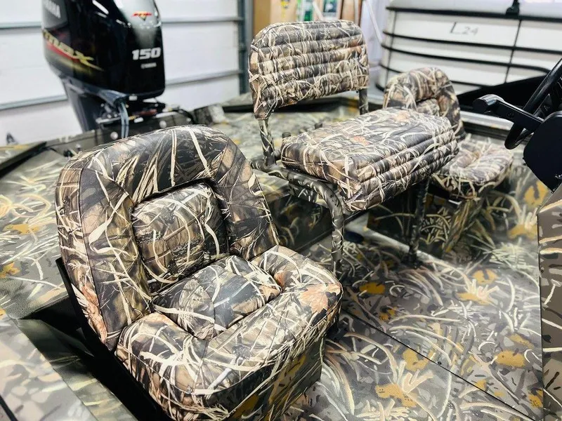 Slide: The Image of 2025 War Eagle Blackhawk 2170 boat with camo seats and powerful outboard motor. - 7