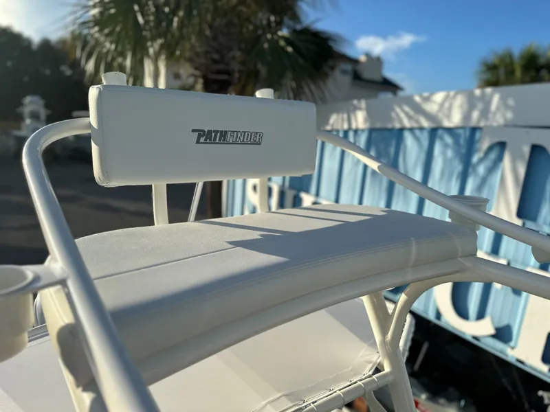Slide: The Image of 2025 Pathfinder 2600 TRS boat seat with logo, outdoor setting, palm tree in background. - 14