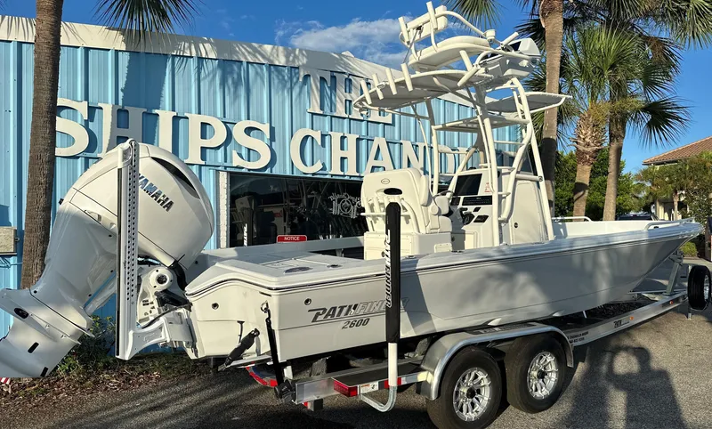 Slide: The Image of 2025 Pathfinder 2600 TRS boat on trailer outside marine shop. - 18