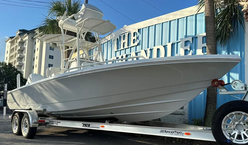 Slide: The Image of 2025 Pathfinder 2600 TRS boat on trailer outside The Chandler building. - 2