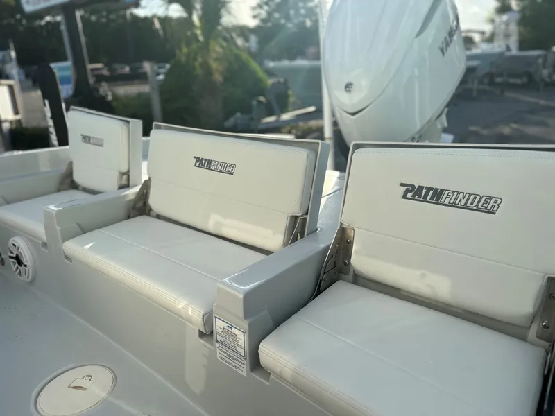 Slide: The Image of 2025 Pathfinder 2600 TRS boat seats and engine in sunlight. - 4