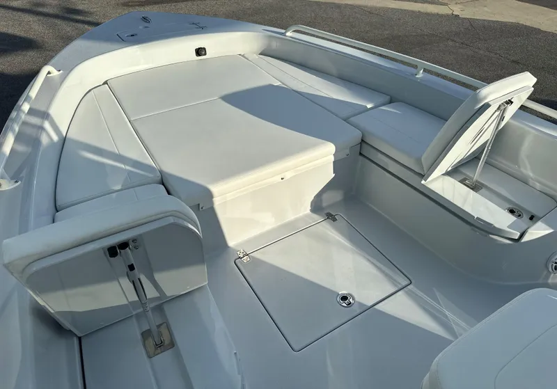 Slide: The Image of 2025 Pathfinder 2600 TRS boat interior with white cushioned seating and storage compartments. - 7