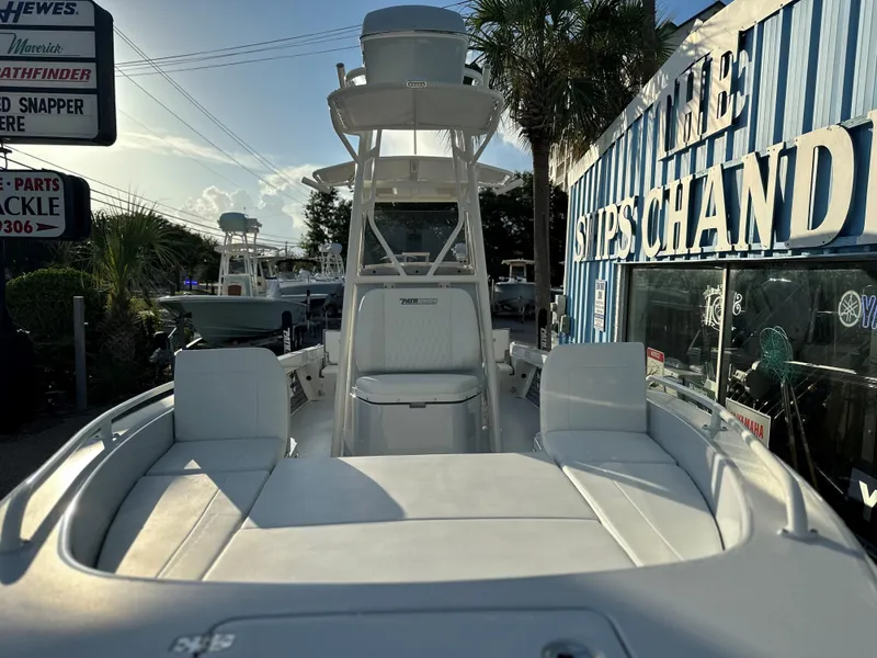 Slide: The Image of 2025 Pathfinder 2600 TRS boat at a marina, front view with seating and console. - 9