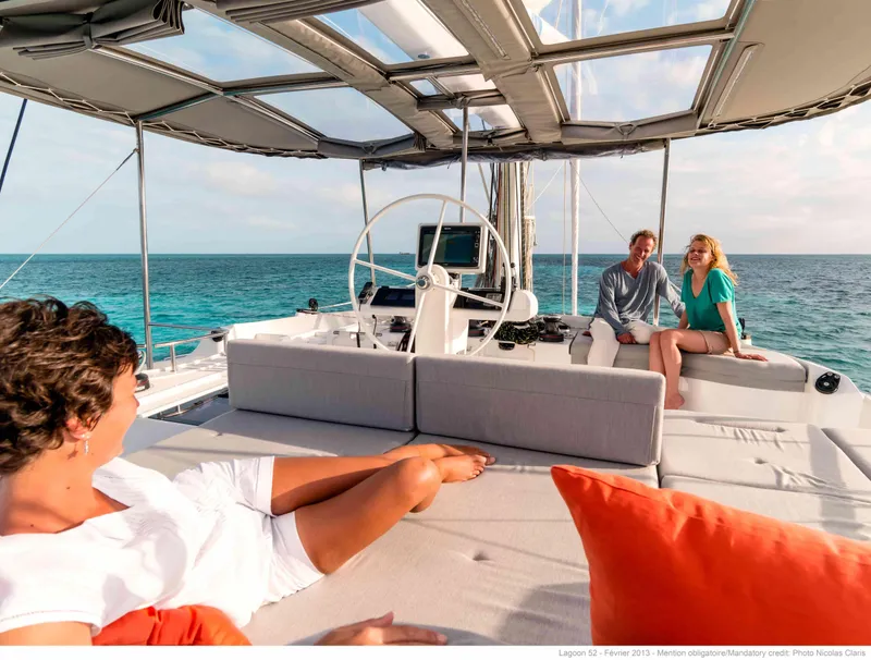 Slide: The Image of Luxurious Lagoon 52 F yacht deck with people relaxing, ocean view, 2020 model. - 5