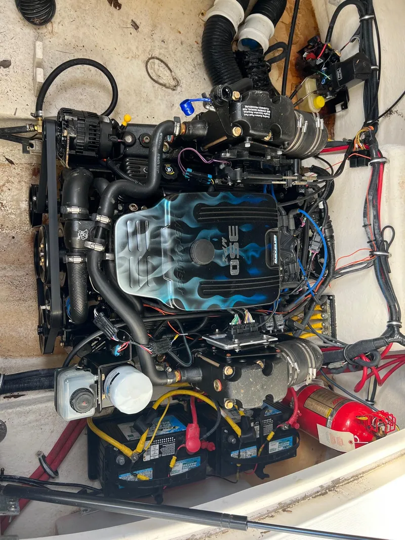 Slide: The Image of Engine of a 2008 Chaparral Signature 250 boat with visible wiring and components. - 10