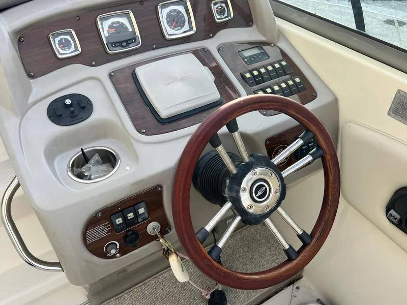 Slide: The Image of 2008 Chaparral Signature 250 boat dashboard with wood accents and steering wheel. - 5