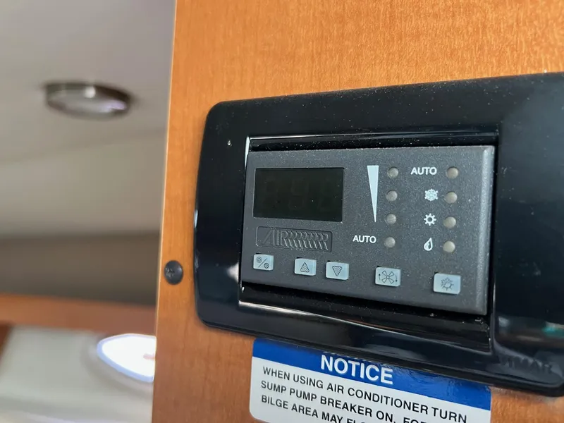 Slide: The Image of Control panel on 2008 Chaparral Signature 250 boat with air conditioner notice. - 8