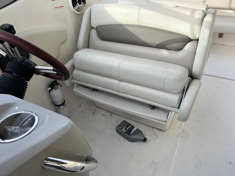 Slide: The Image of 2008 Chaparral Signature 250 boat interior with white seating and steering wheel. - 9