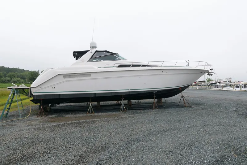 The Image of 1993 Sea Ray 500 Sundancer yacht on dry dock for maintenance. - 0