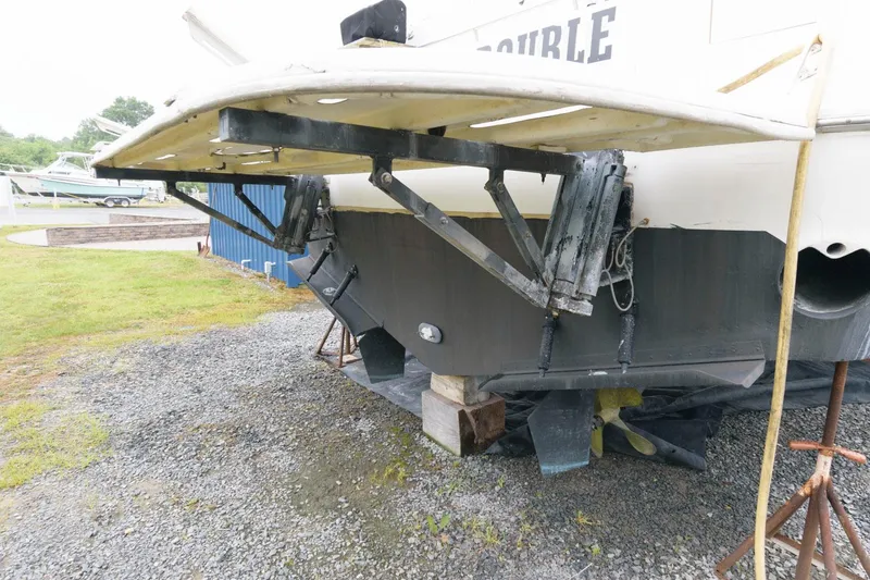 Slide: The Image of 1993 Sea Ray 500 Sundancer boat on dry dock, showing stern and propeller. - 10