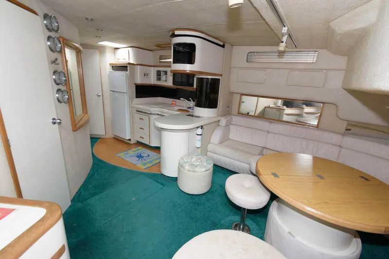 Slide: The Image of 1993 Sea Ray 500 Sundancer interior with kitchen, dining area, and seating. - 11