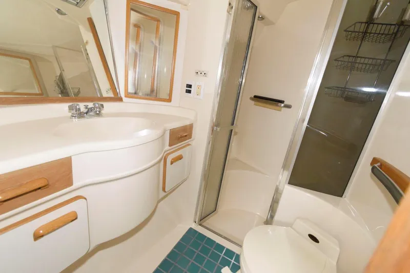 Slide: The Image of 1993 Sea Ray 500 Sundancer bathroom with shower, sink, and toilet. - 16