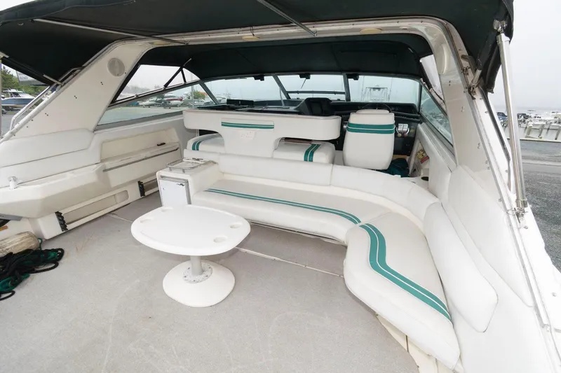 Slide: The Image of 1993 Sea Ray 500 Sundancer yacht interior with white and green seating. - 2