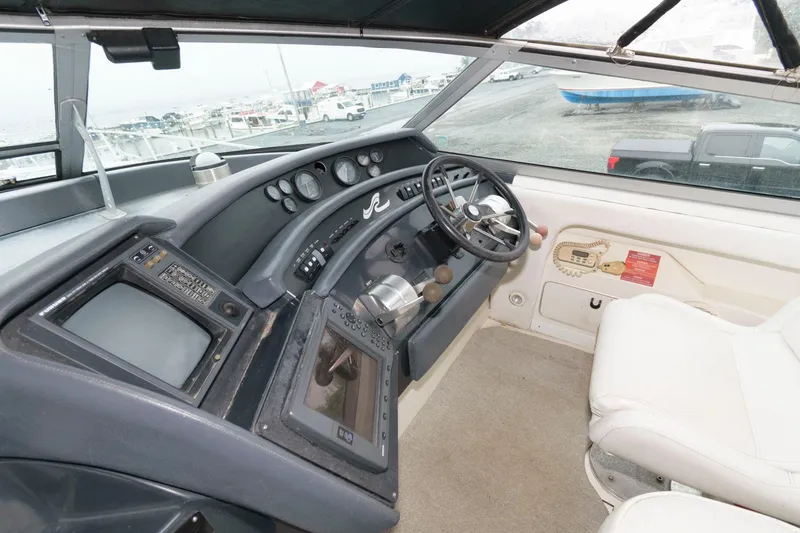 Slide: The Image of 1993 Sea Ray 500 Sundancer helm with navigation instruments and steering wheel. - 5