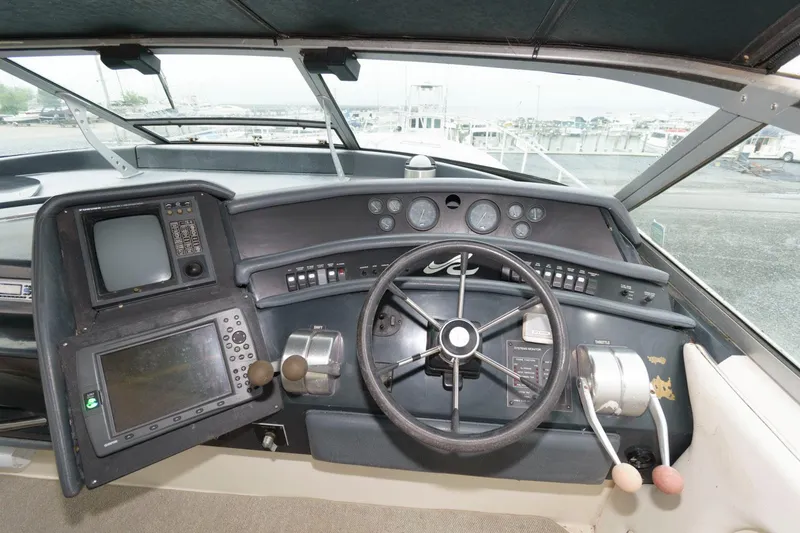 Slide: The Image of 1993 Sea Ray 500 Sundancer helm with navigation instruments and steering wheel. - 6