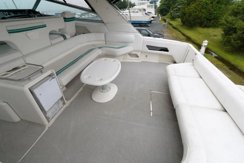 Slide: The Image of 1993 Sea Ray 500 Sundancer yacht interior with white seating and table. - 8