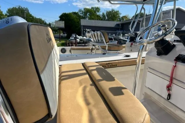 Slide: The Image of 2023 Sea Chaser 22 HFC boat interior with tan seating and steering console. - 7