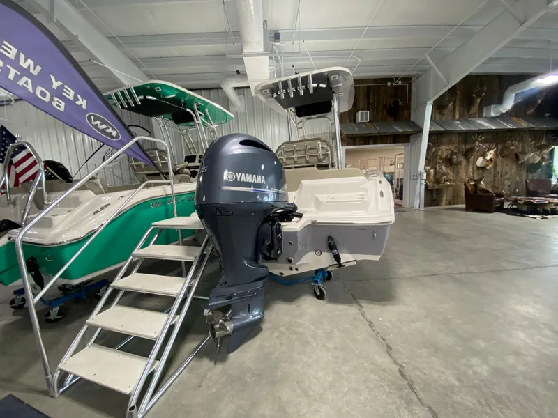 Slide: The Image of 2024 Key West 219 FS boat with Yamaha outboard motor in showroom. - 1