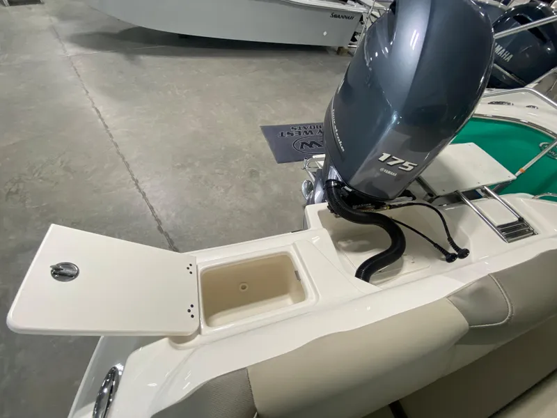 Slide: The Image of 2024 Key West 219 FS boat with Yamaha 175 engine, open storage compartment. - 15